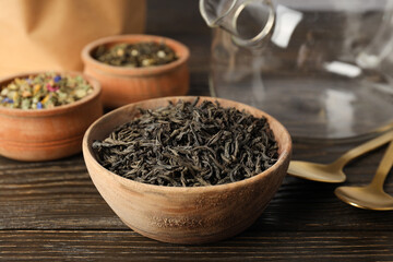 Concept of cooking tea with different types of tea on wooden background
