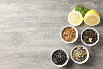 Concept of cooking tea with different types of tea on gray wooden background