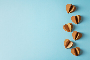 Fathers day concept with craft sustainble paper hearts on blue background