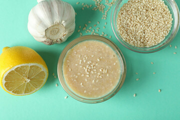Concept of tasty food with tahini sauce on mint background