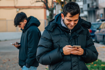 young people on the street with mobile phone