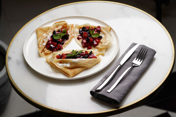 Crepes served with fresh berries and apples
