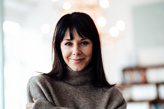 Mature woman smiling at cafe