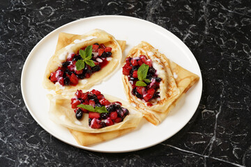 Crepes served with fresh berries and apples
