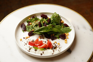 Beet salad served on white table, close up.