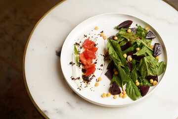 Beet salad served on white table, close up.