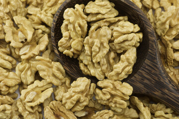 group of walnuts in wooden spoon