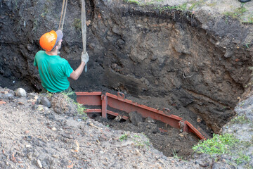 A team of builders is engaged in the repair of a sewer well. Replacement of reinforced concrete...