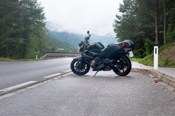 Fototapeta na wymiar motorcycle on the side of a rural mountain alpine road