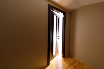 The light revealing through the half open door in the house