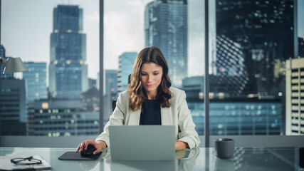 Static Portrait of Successful Caucasian Businesswoman Sitting at Her Desk Working on Laptop...