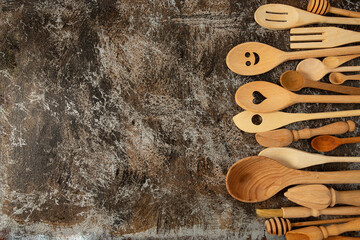 beautiful wooden spoons and utensils on stone surface