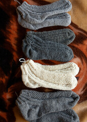 knitted hand made gloves and socks made of woolen thread - 473507130