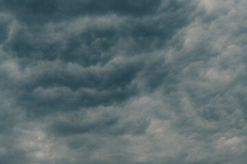 Dramatic stormy cumulus clouds at the sky in spring dusk