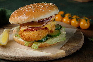 burger with chicken on a wooden board