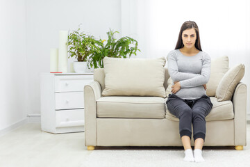 Obraz premium Photo of pregnant woman looking at camera and touching her stomach.