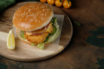 burger with chicken on a wooden board