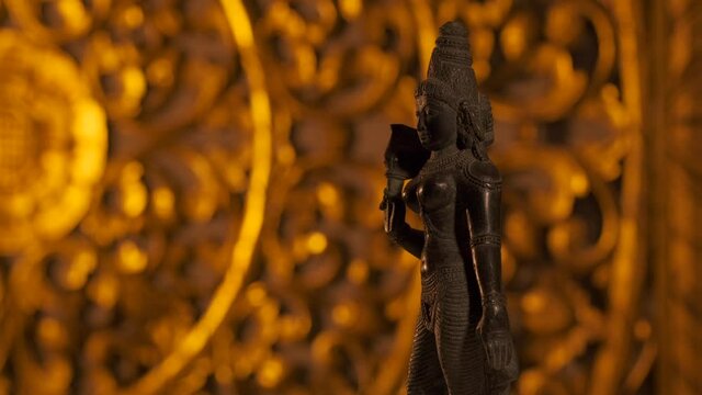 Statue of Parvati goddess, wife of Shiva, Hinduism religion. Turntable, light fading in, turning on beam.
