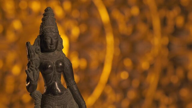 Statue of Parvati goddess, wife of Shiva, Hinduism religion. Turntable motion, light fading out.