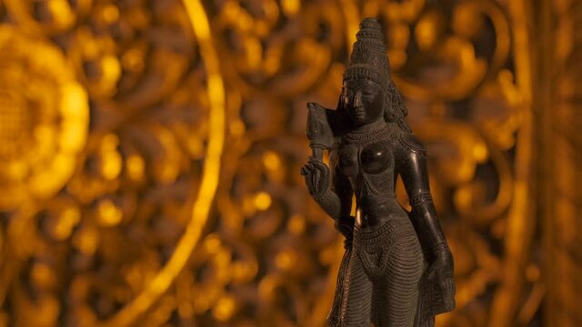 Statue of Parvati goddess, wife of Shiva, Hinduism religion. Turntable motion, light fading out.