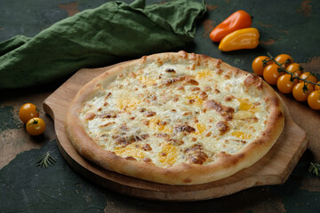 Pizza 4 cheeses on a green wooden background