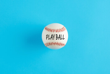 Baseball ball on blue background with the word play ball.
