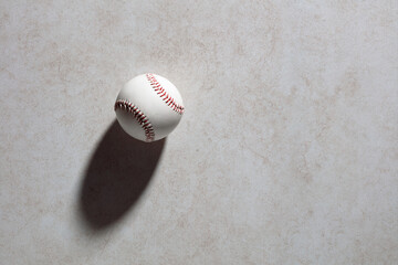 Baseball ball on dark gray textured background with copy space.