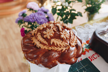 round wedding loaf decorated with flowers, Russian tradition at the ceremony