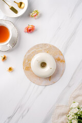 Trendy mousse cake with mirror glaze decorated. Modern european desserts at white marmer stone background.