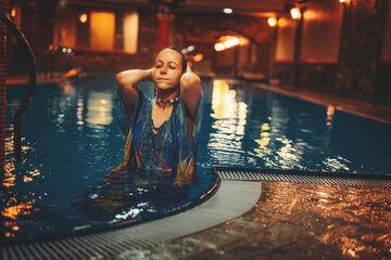 Pretty young woman relaxing in the pool.