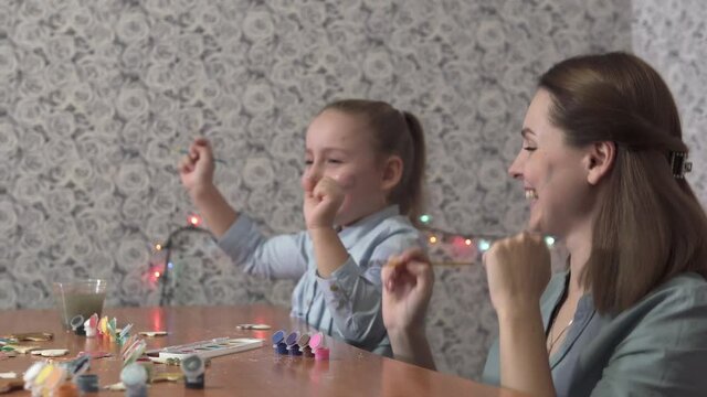 The cheerful family dances and makes toy cookies and enjoys the process. The family spends time at home together over Christmas and New Years.