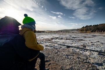 Mother and preschool son wating for the Geysir explode in Iceland