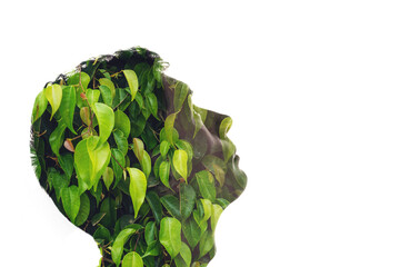 Combination of the silhouette of a man face and a picture with green leaves. Concept of the connection people and nature