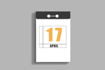 April 17. 17th day of month, calendar date.White page of tear-off calendar, on gray insulated wall. Concept of day of year, time planner, spring month