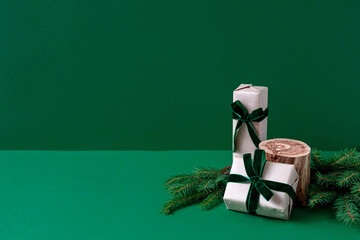 Christmas mockup. Empty wooden podium, gift wrapped in craft and velvet ribbon, natural fir...