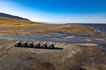 Amphibious offroad vehicles moving thru deserted mouth of the river lena in Yakutia
