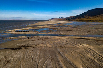 Amphibious offroad vehicles moving thru deserted mouth of the river lena in Yakutia
