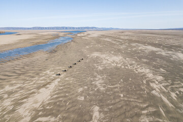 Amphibious offroad vehicles moving thru deserted mouth of the river lena in Yakutia