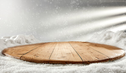 Wooden table with fresh snow and a free place on a beautiful Christmas day, shadow on the wall. 