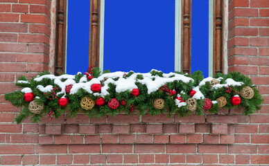 Fototapeta na wymiar window in a brick wall with a Christmas decoration. mockup for inserting an image or text
