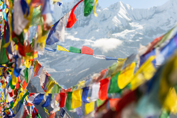 Himalayas framed by long strings of colorful Tibetan prayer flags flutter in the wind. Annapurna...