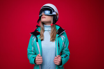 Portrait of a young woman in a ski helmet and glasses