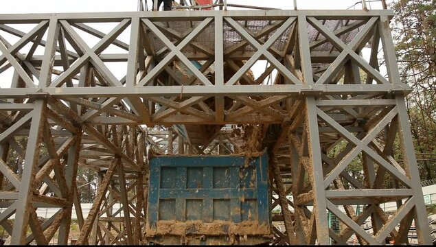 Loading soil to a dump truck durring tunnel boring machine work. New metro line under construction