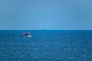 Floating ship in the blue sea.
