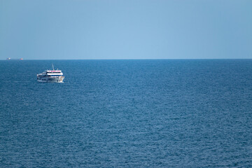 Big ship in blue sea and sky.