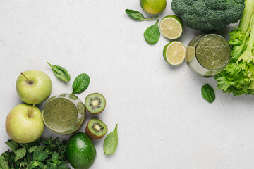 Green smoothie in glasses and vegetables and fruits for preparing healthy drink. Raw vegan juice, top view