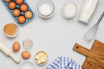 Variety of ingredients and baking utensils on white table. Kitchen background with copy space