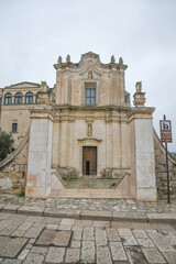 The facade of an ancient church in Matera, an ancient city built into the rock. It is located in the Basilicata region, Italy.