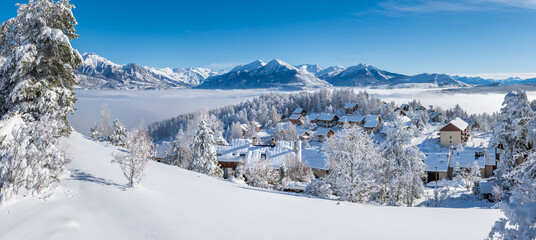 Laye winter ski resort covered in fresh snow with panoramic view of the mountains of Ecrins National Park. Champsaur valley in the French Alps. Hautes-Alpes, France