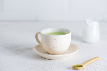 Matcha latte tea with coconut milk and hemp seeds in a mug. Selective focus.